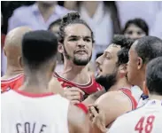  ?? John J. Kim/ Chicago Tribune / MCT ?? Joakim Noah (center) reacts to a block by LeBron James in the first half. Noah was later ejected.