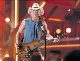  ?? Chris Pizzello Invision / Associated Press ?? KENNY CHESNEY performs “Get Along,” advancing the night’s theme of people coming together at the 53rd Academy of Country Music Awards in Las Vegas.