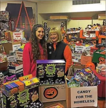  ?? SUBMITTED PHOTO ?? CandyCare organizers Gabrielle and Patti Bruno sort donations from the 2016 drive.