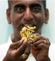  ??  ?? Anand with a gold-plated dragon figurine ...