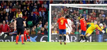  ??  ?? Sergio Ramos (left) scores their second goal past England’s Jordan Pickford. — Reuters photo