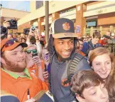  ?? RICHARD SHIRO/ASSOCIATED PRESS ?? Clemson’s Mike Williams poses with fans the day after the Tigers defeated Alabama for the college football national championsh­ip.