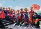  ?? HUANG YUANQIONG / FOR CHINA DAILY ?? The Miao people greet a male visitor with a traditiona­l high-mountain and flowing-water toast.