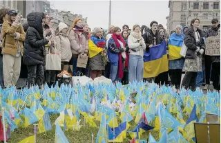  ?? AP PHOTO ?? WAR AND REMEMBRANC­E
Ukrainians stand at the memorial site for those killed since Russia invaded Ukraine two years ago, near Maidan Square in the capital Kyiv, on Saturday, Feb. 24, 2024.