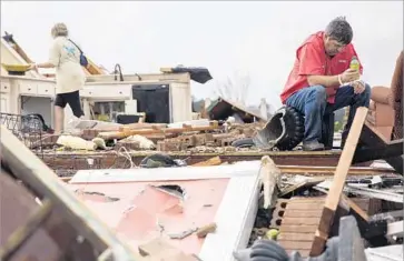  ?? Branden Camp Associated Press ?? JEFF BULLARD sits in what used to be the foyer of his home in Adel, Ga., as his daughter Jenny looks for belongings. “There are no words to tell you how bad this is,” said one emergency management official.