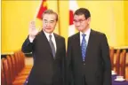  ??  ?? BEHROUZ MEHRI/REUTERS Chinese State Councilor and Foreign Minister Wang Yi (L) and Japan’s Foreign Minister Taro Kono gesture at their meeting in Tokyo, Japan.