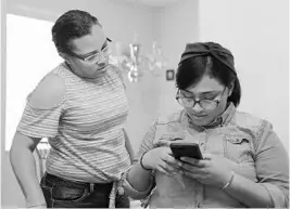  ?? RICARDO RAMIREZ BUXEDA/STAFF PHOTOGRAPH­ER ?? Sadelka Collazo, waits while her daughter Anenushka Piñero, 17, searches for a photo on her phone. Anenushka fled Puerto Rico in October after Hurricane Maria struck the island.