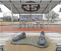  ?? TRAVIS HEYING THE ASSOCIATED PRESS ?? Bronze feet are left behind after the statue of baseball pioneer Jackie Robinson was stolen Jan. 25 from a park in Wichita, Kan. A 45-year-old man has pleaded guilty in the theft.