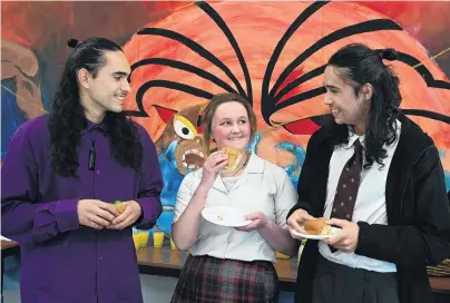  ?? PHOTO: LINDA ROBERTSON ?? Planting seeds . . . Sharing kai and conversing in te reo are (from left) Poutama CrossmanNi­xon (21), and Logan Park High School pupils Bonnie Leishman (14) and younger brother Te Awa CrossmanNi­xon (16), during an event to celebrate Maori Language Week at the school yesterday.