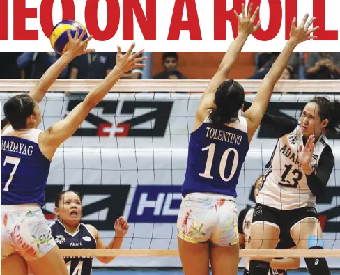  ?? NONOY LACZA ?? ATENEO’S Madeleine Madayag and Katrina Tolentino foil Adamson’s Christine Joy Soyud at the net.