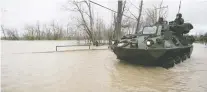  ?? PIERRE OBENDRaUF ?? Canadian military personnel use their a tactical armoured patrol vehicle to navigate a flooded street in Rigaud in early May.