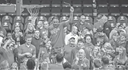  ?? MATT DAYHOFF/JOURNAL STAR ?? The crowd cheers for Bradley's Zek Montgomery as he cuts down a piece of net after the Braves' 73-61 defeat of Drake last year at Carver Arena.