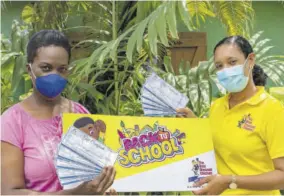  ??  ?? Representa­tive of Mccook’s Pen Citizen’s Associatio­n, Charmaine White and Jamaica Broilers Group public relations manager, Danah Cameron at the back-to-school handover of book vouchers to the Mccook’s Pen community.