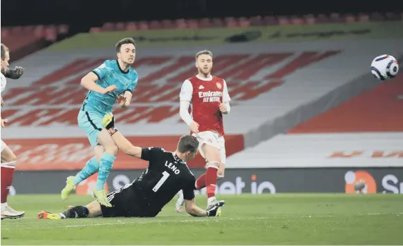  ??  ?? Liverpool’s Diogo Jota scores their third goal of the game against Arsenal.