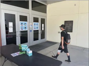  ?? JUSTIN COUCHOT — ENTERPRISE-RECORD ?? Butte College student Jerry Saechao walks Wednesday into the Arts Building at Butte College in Butte Valley. Butte College has hand sanitizers, masks and other personal protective equipment outside of its buildings for students and staff.