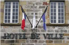  ?? — AFP ?? French flags are seen at half-mast outside Brive-la-gaillarde city hall during a memorial ceremony as part of a national day of mourning.