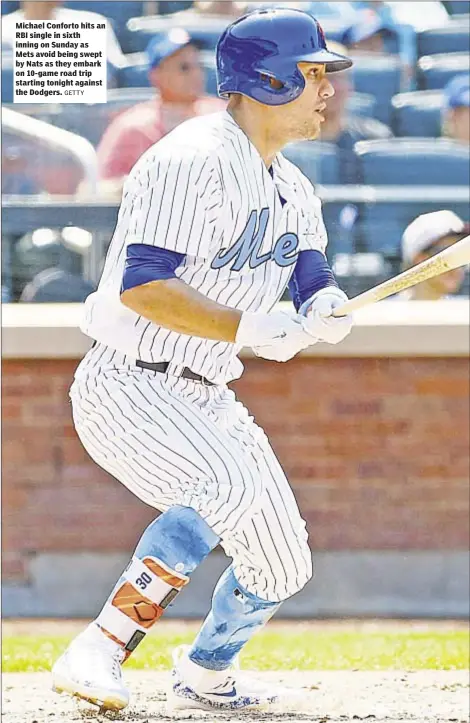  ?? GETTY ?? Michael Conforto hits an RBI single in sixth inning on Sunday as Mets avoid being swept by Nats as they embark on 10-game road trip starting tonight against the Dodgers.