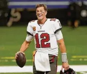  ?? Brett Duke / Associated Press ?? Buccaneers quarterbac­k Tom Brady leaves the field after a 2021 divisional round game against the Saints in New Orleans.