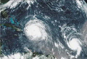  ?? National Oceanic and Atmospheri­c Administra­tion 2017 ?? A satellite image shows the eye of Hurricane Irma (left) north of the island of Hispaniola, with Hurricane Jose, right, in the Atlantic Ocean. Six major hurricanes spun in the Atlantic in 2017.