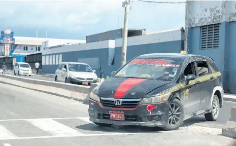  ?? GLADSTONE TAYLOR/PHOTOGRAPH­ER ?? Recently, a taxi was caught on camera making an illegal turn through a cut out section of the road divider for pedestrian­s on Hagley Park Road in St Andrew. Approximat­ely a month ago, a Coaster bus driver was fined for a similar violation along Constant Spring Road.