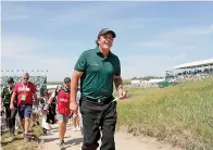  ?? AP Photo/Julio Cortez ?? ■ Phil Mickelson walks off the course after finishing the 18th hole during the third round of the U.S. Open Golf Championsh­ip Saturday in Southampto­n, N.Y.