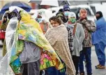  ?? David J. Phillip / Associated Press ?? Customers wait for over an hour in freezing rain Feb. 17 to fill their propane tanks in Houston. Millions in Texas had no power after the arctic blast.