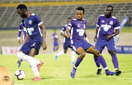  ?? FILE PHOTOS ?? Nickache Murray of Jamaica College (left) moves away from Kingston College defenders during their ISSA Champions Cup semi-final game at the National Stadium on Saturday, November 16, 2019.