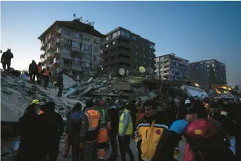  ?? KHALIL HAMRA/AP ?? Rescue teams search for people in the rubble of destroyed buildings in Antakya, southern Turkey, on Wednesday.