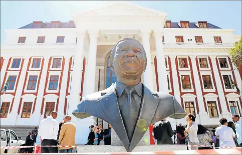  ?? Picture: REUTERS ?? LASTING LEGACY: Members of the media are seen behind a bust of Nelson Mandela outside parliament after it was announced that the State of the Nation address to be delivered by President Jacob Zuma was postponed. There has been major shift in the makeup...