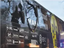  ?? Martin Meissner / Associated Press ?? A window of Dortmund's team bus is damaged after an explosion before a Champions League quarterfin­al.