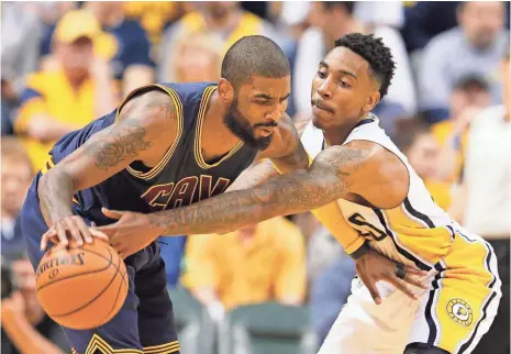  ?? BRIAN SPURLOCK, USA TODAY SPORTS ?? Cavaliers guard Kyrie Irving, left, being defended by Jeff Teague, had 28 points Sunday but shot 41.9% for the series.