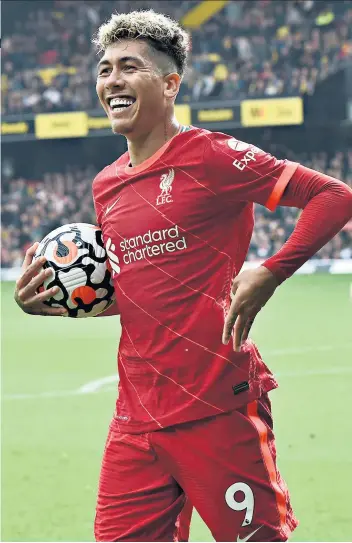  ?? ?? On the ball: Roberto Firmino celebrates the rout of Watford with his hat-trick