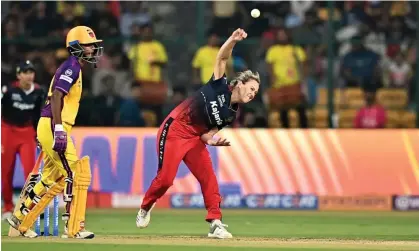  ?? Photograph: Idrees Mohammed/AFP/Getty Images ?? Royal Challenger­s Bangalore's Ellyse Perry bowls. The Australian starred with the bat against UP Warriorz in the Women’s Premier League and smashed a car window with one six.