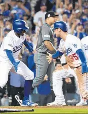  ?? Wally Skalij Los Angeles Times ?? THE DODGERS’ Cody Bellinger is greeted a home plate by Curtis Granderson after scoring Friday.