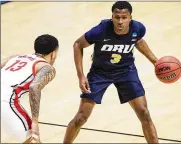  ?? ROBERT FRANKLIN / AP ?? Oral Roberts’ Max Abmas (right) drives against Ohio State’s CJ Walker during the first round game March 19. Abmas had 29 points in the 15th-seed’s opening upset of No. 2 Ohio State in West Lafayette, Ind.