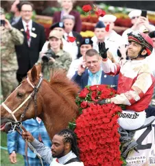  ?? — AFP photo ?? Leon rides Rich Strike into the winner’s circle after Rich Strike won the 148th running of the Kentucky Derby at Churchill Downs in Louisville, Kentucky.