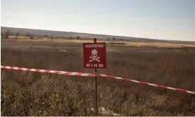  ?? Photograph: Alessio Mamo/The Guardian ?? A sign indicating the presence of mines on the road to Kherson.