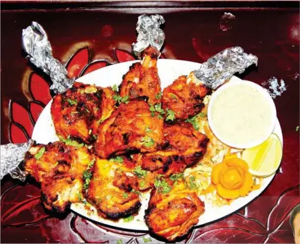  ??  ?? Chicken tandoori is one of the most popular dishes at Swagat Indian Restaurant.