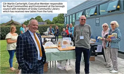  ?? ?? Cllr Martin Cartwright, Executive Member responsibl­e for Rural Communitie­s and Environmen­t at the borough council with members of Groby Community Library which has received new tables from the fund.