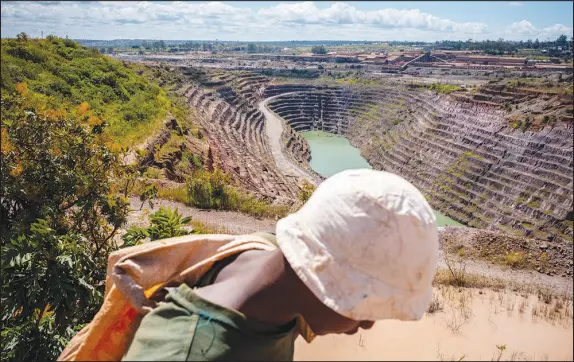  ?? ASHLEY GILBERTSON / THE NEW YORK TIMES ?? A youth searches for stray cobalt that may have been dropped by trucks April 25 at a mine in Kolwezi, Congo. Cobalt is vital for electric vehicles and the worldwide push against climate change, but the U.S., inexplicab­ly, has ceded Congo’s cobalt to China.