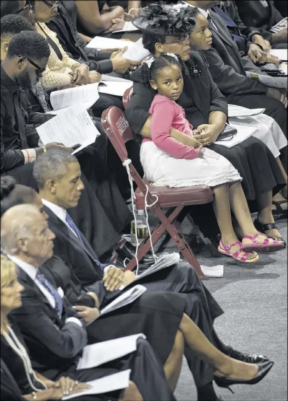  ?? STEPHEN CROWLEY / THE NEW YORK TIMES ?? Malana Pinckney, a daughter of the late Rev. Clementa Pinckney, looks to President Barack Obama during a funeral service for her father at the TD Arena in Charleston, S.C. Pinckney was killed in the Charleston church shooting on the night of June 17,...