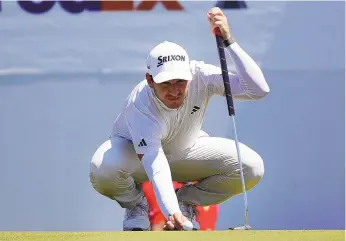  ?? MICHAEL WYKE / ASSOCIATED PRESS ?? Alejandro Tosti places his ball on the 15th green before putting during the first round of the Houston Open on Thursday. Tosti is tied for the lead with four other golfers going into Sunday’s final round.