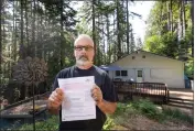  ?? PHOTO BY JIM GENSHEIMER ?? Don Baker shows a nonrenewal insurance notice from State Farm at his home in Boulder Creek on June 3. Baker is one of countless California­ns who are suddenly finding it harder to insure their homes because of recent disasters.
