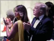  ?? PABLO MARTINEZ MONSIVAIS — THE ASSOCIATED PRESS ?? President Donald Trump and first lady Melania Trump applaud as they attend a dinner with Australian Prime Minister Malcolm Turnbull aboard the USS Intrepid, a decommissi­oned aircraft carrier docked in the Hudson River in New York, Thursday.