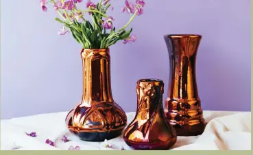  ??  ?? top A trio of vases in the new iridescent Copper glaze. left from top Steve McBride, in the Pewabic showroom. • Pewabic Hex paperweigh­ts, a tribute to the hexagonal vessels Mary Chase Perry Stratton used for glaze tests. • The historic pottery building dates to 1907. Mary Chase Perry married the architect, William Stratton, in 1917.