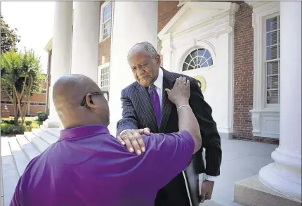  ?? MIKE BROWN/THE COMMERCIAL APPEAL ?? Stanley Dentley (left), logistics coordinato­r for athletics at LeMoyne-Owen College, lets outgoing president Johnnie B. Watson know he will be missed after the June 11 announceme­nt that Watson would be succeeded by Dr. Andrea Lewis Miller as the...