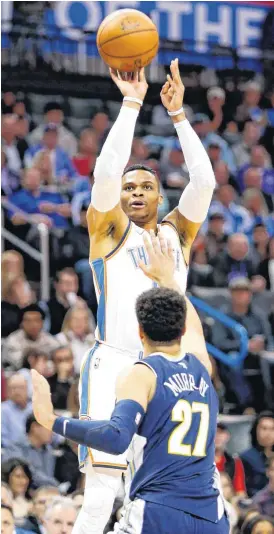  ?? NATE BILLINGS, THE OKLAHOMAN] [PHOTO BY ?? Oklahoma City’s Russell Westbrook shoots as Denver’s Jamal Murray defends during Monday’s game between the Oklahoma City Thunder and the Denver Nuggets.