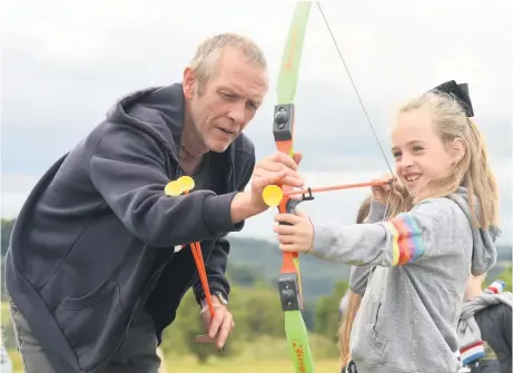  ??  ?? Crickley Hill was full of activity as a Go Wild! event was held last weekend. Held in partnershi­p with the Gloucester­shire Wildlife Trust and the National Trust, activities included archery, welly wanging and face painting. Pictured clockwise from top: John Putley from Gloucester Heritage Hub shows Lubomir Belica and Jana Bukova some Norman Armour; Esmae Clarke, nine, tries archery; and Evelyn Riach, six looks at moths. Pictures: Nick Parford Photograph­y