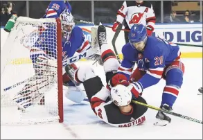  ?? Bruce Bennett / Associated Press ?? The Rangers’ Chris Kreider (20) hits the Devils’ Nathan Bastian after he collided with Rangers goalie Igor Shesterkin during the third period Saturday.