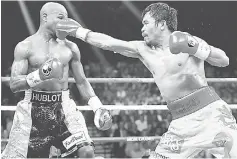  ??  ?? Manny Pacquiao (right) throws a right at Floyd Mayweather Jr during their welterweig­ht unificatio­n championsh­ip bout at MGM Grand Garden Arena in Las Vegas, Nevada in this May 2 file photo. — AFP photo